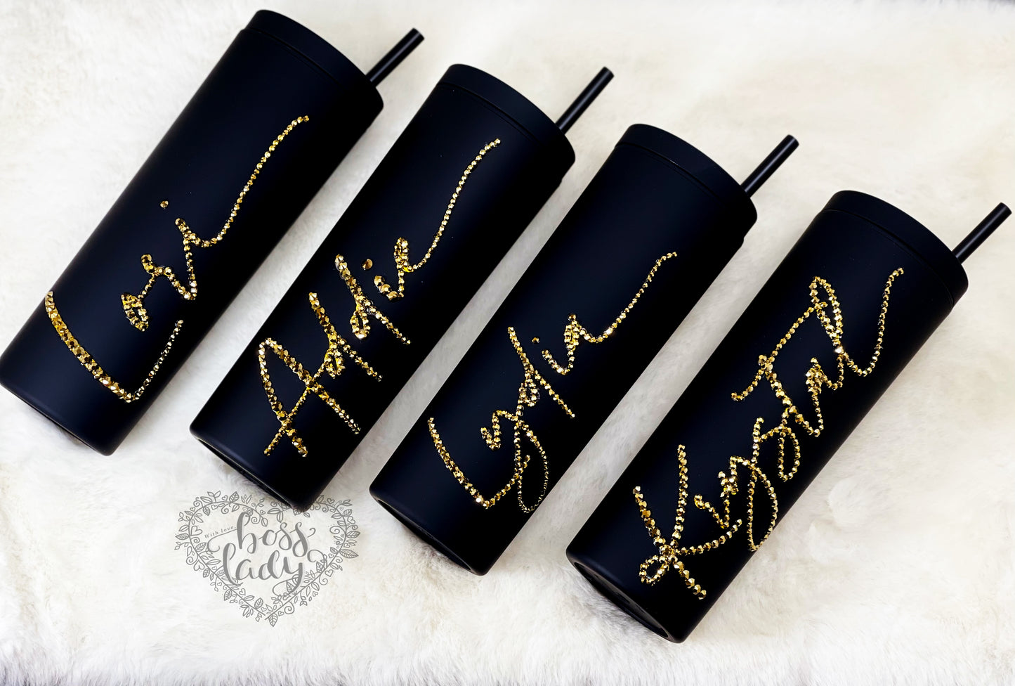 Personalized rhinestone name tumbler in cursive. Available in many colors. Pictured black tumbler with gold cursive rhinestone names.